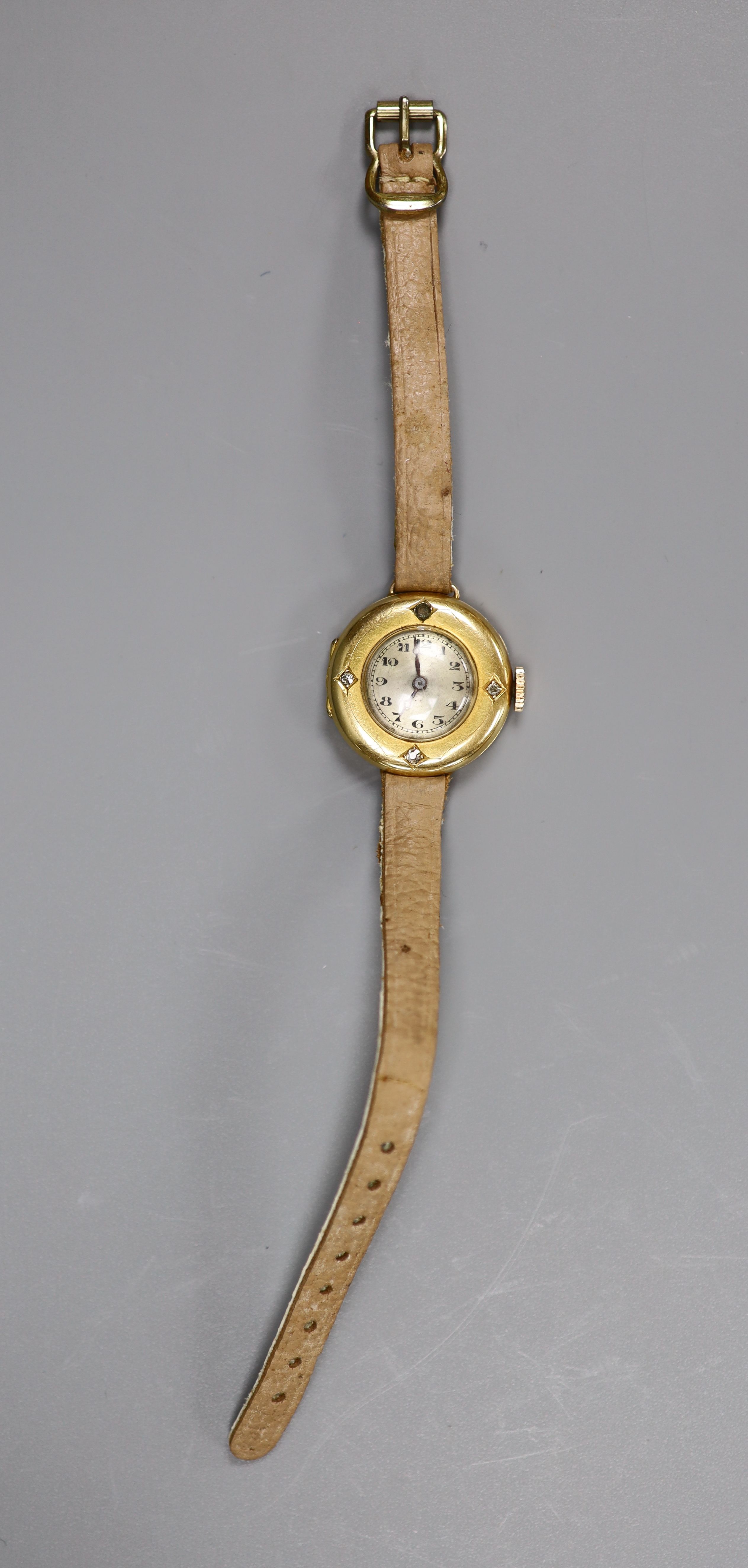 A lady's early to mid 20th century 18k yellow metal and diamond set manual wind wrist watch, on a leather strap